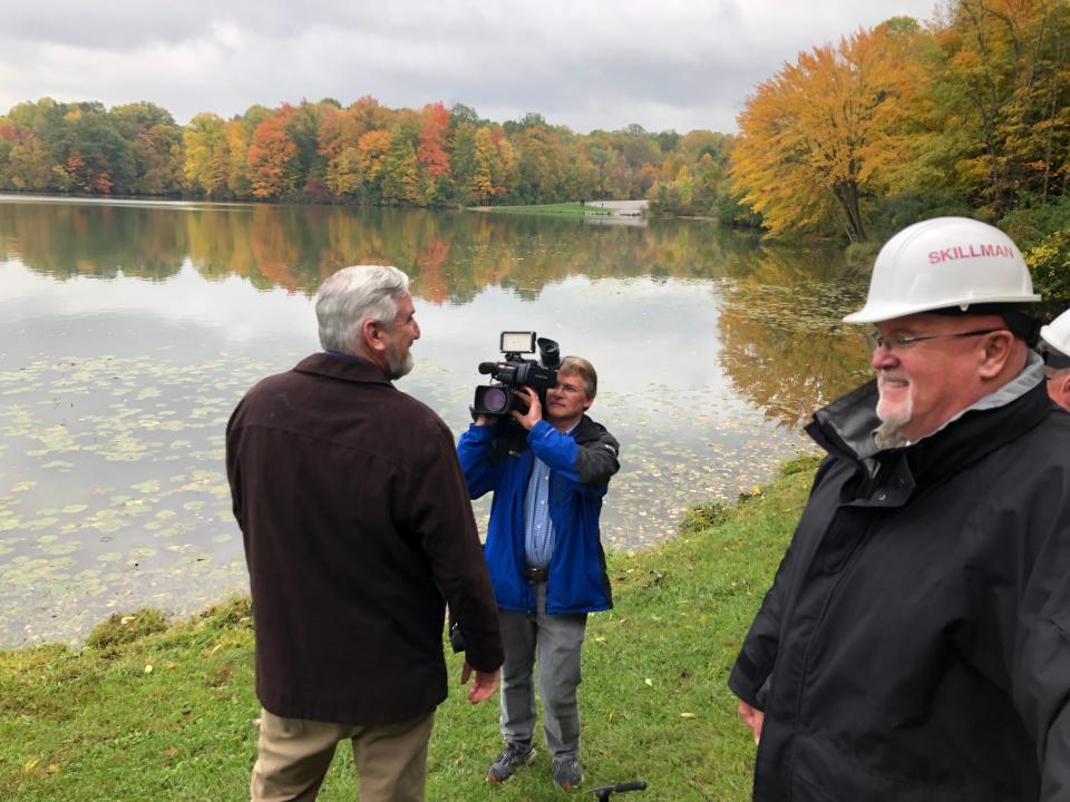 Indiana Gov. Eric Holcomb, left, takes in the Worster Lake view Thursday, Oct. 19, 2023, where the inn at Potato Creek State Park would be built in North Liberty, with Terry Coleman, director of Indiana State Parks, at right.