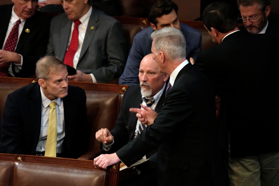 House Republican Leader Kevin McCarthy, R-Calif., talks to Chip Roy, R-Texas, and Jim Jordan, R-Ohio, in the House Chamber on Wednesday.