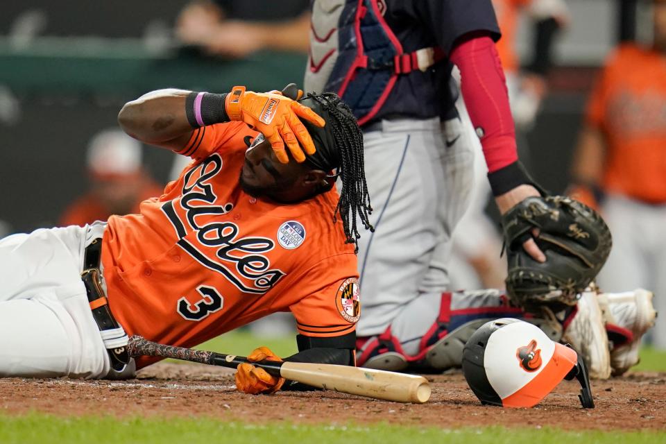 Baltimore Orioles' Jorge Mateo (3) lies on the ground after avoiding a throw by Guardians relief pitcher Enyel De Los Santos during the eighth inning of Friday night's game. The Guardians won 6-3. [Julio Cortez/Associated Press]