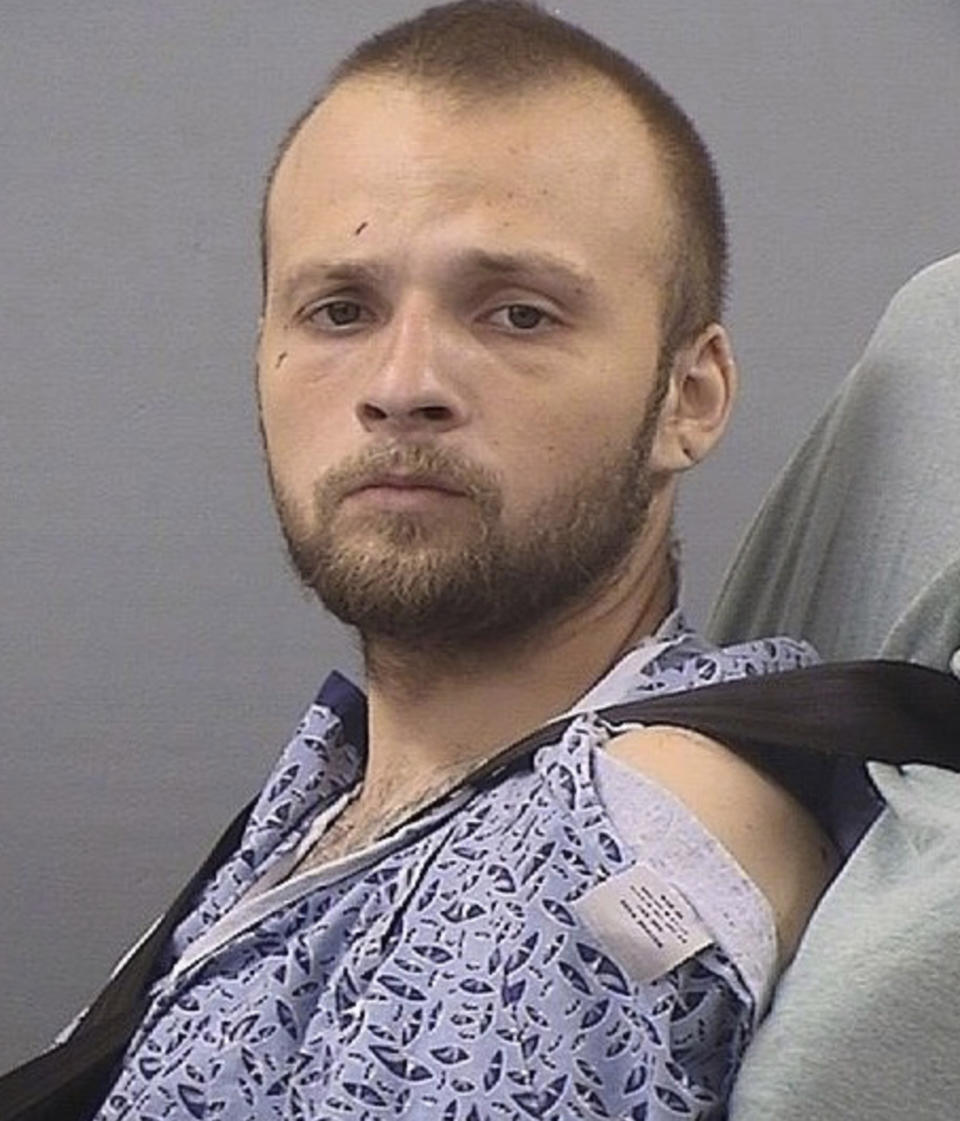 This Friday, May 10, 2019, photo provided by the Tennessee Bureau of Investigation shows Michael Cummins. Cummins, 25, has been charged in connection to the murder of at least seven people at two different locations in Sumner County, Tenn., on April 27. Cummins was charged May 10 after being released from a hospital. Cummins was shot during his arrest. (Tennessee Bureau of Investigation via AP)