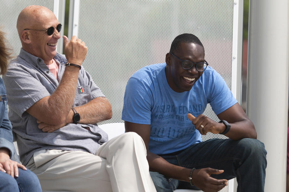 Grand Haven city council member, Kevin McLaughlin, left, laughs with Michigan Lieutenant Governor Garlin Gilchrist, right, before opening remarks and the official start of Pride Fest at the Lynne Sherwood Waterfront Stadium in Grand Haven, Mich., on Saturday, June 10, 2023. The festival — which organizers had hoped would attract at least 500 attendees — drew thousands of people from all over who came to experience the first-time event's drag show, dance party and vendor-filled streets. (AP Photo/Kristen Norman)