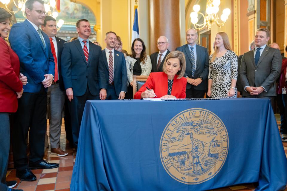 Governor Kim Reynolds signs a sweeping property tax cut bill that will rein in local governments' revenue growth and provide new tax breaks for military veterans and seniors, Thursday, May 4, 2023. 