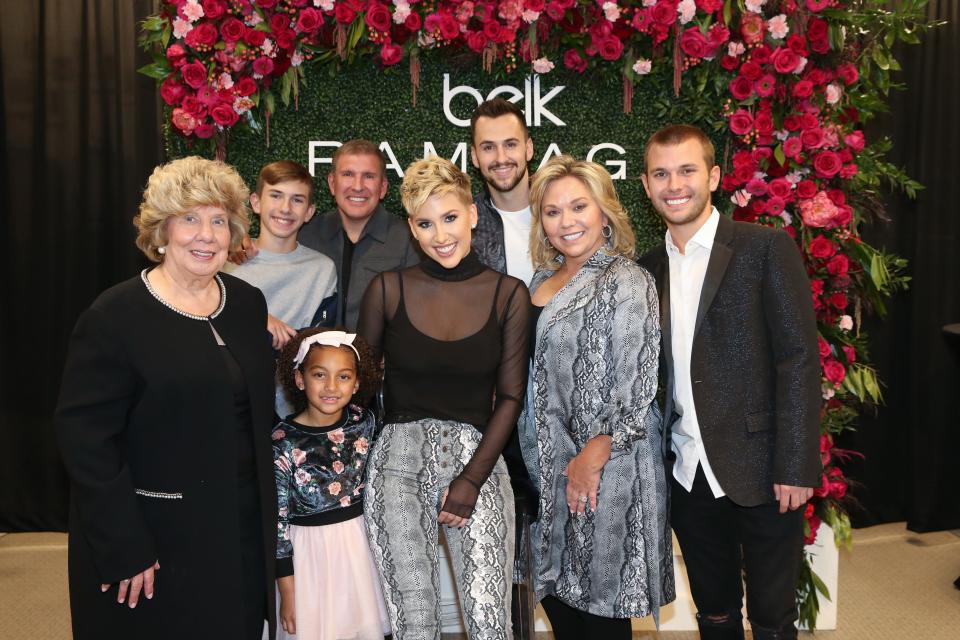 Faye Chrisley (front left) Chloe Chrisley, Savannah Chrisley, Julie Chrisley, Chase Chrisley and Grayson Chrisley (back left), Todd Chrisley and Nic Kerdiles pose at Belk at Cool Springs Galleria Mall on Nov. 5, 2019, in Franklin, Tennessee.