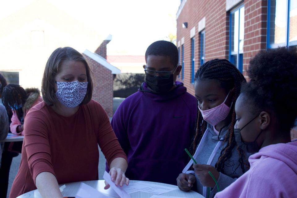 Rebecca Kelly, APEX Honors Program director at EastSide Charter School, instructs EastSide students, Gabe Bass, Faith Brown and Blair Mundy at The Warehouse in Wilmington on Monday, November 8, 2021.