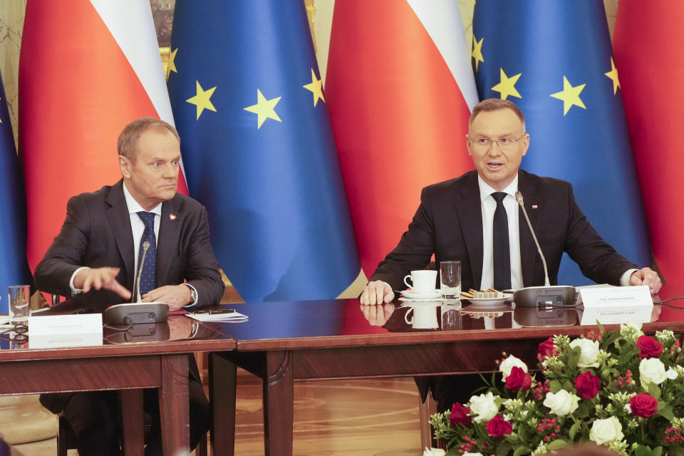 Poland's Prime Minister Donald Tusk, left, and President Andrzej Duda attend a meeting of the Cabinet Council, a consultation format between the president and the government, in Warsaw, Poland, on Tuesday Feb. 13, 2024. Tusk says he has documentation proving that state authorities under the previous government used powerful Pegasus spyware illegally and that list of victims was “very long.” (AP Photo/Czarek Sokolowski)