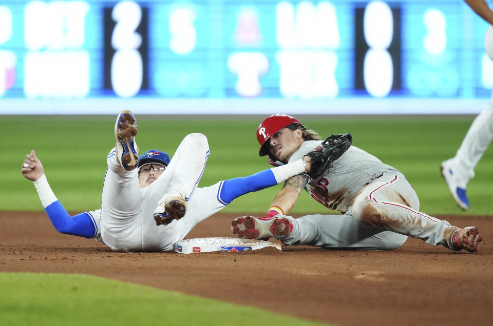 Philadelphia Phillies' Bryson Stott, right, steals second base ahead of the tag from Toronto Blue Jays second baseman Cavan Biggio (8) during the seventh inning of a baseball game in Toronto on Tuesday, Aug. 15, 2023. (Nathan Denette/The Canadian Press via AP)