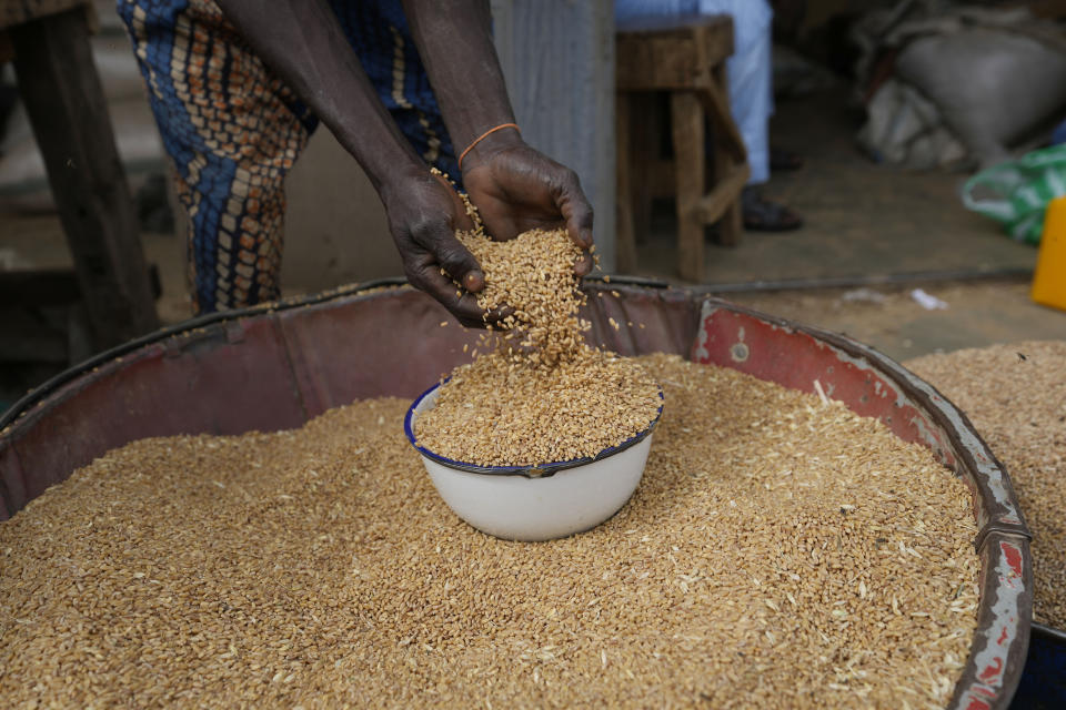 A man sells grain in Dawanau International Market in Kano Nigeria, Friday, July 14, 2023. Nigeria introduced programs before and during Russia's war in Ukraine to make Africa's largest economy self-reliant in wheat production. But climate fallout and insecurity in the northern part of the country where grains are largely grown has hindered the effort. (AP Photo/Sunday Alamba)