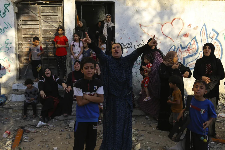 Palestinian women and children react following Israeli airstrikes targeting their neighbourhood in Gaza City, Saturday, Oct. 21, 2023. (AP Photo/Abed Khaled)