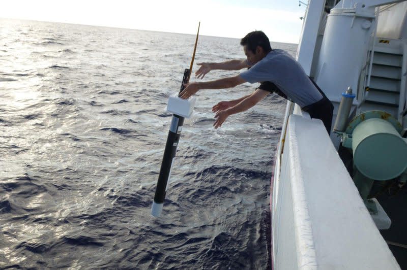 Two program technicians deploy an Argo float in the ocean recently. Photo courtesy of the University of California-San Diego