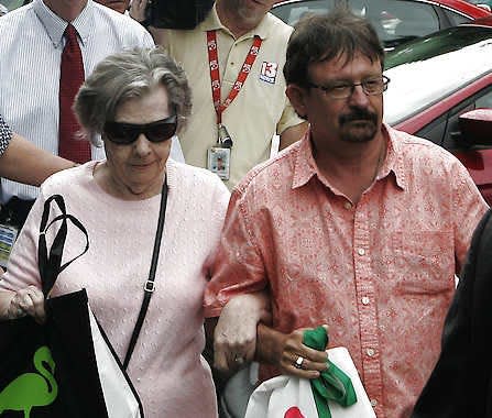 Powerball winner Gloria C. Mackenzie, 84, left, leaves the lottery office escorted by her son, Scott Mackenzie, after claiming a single lump-sum payment of about $370.9 million before taxes on Wednesday in Tallahassee, Fla.