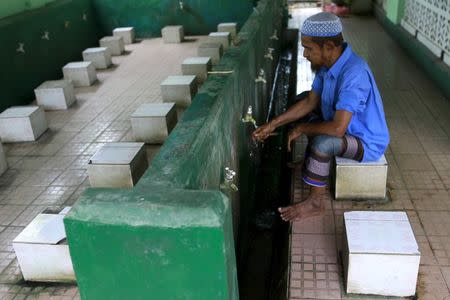A Muslim Rohingya man washes his hands before praying at a mosque in Aung Minglar in Sittwe October 29, 2015. REUTERS/Soe Zeya Tun