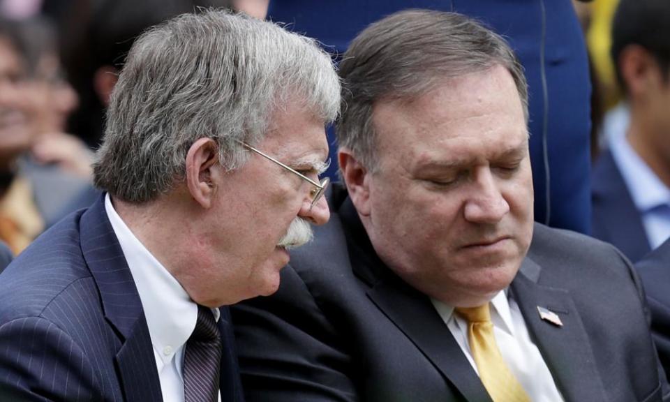 John Bolton and Mike Pompeo confer in the rose garden at the White House in June.