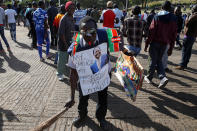 <p>A supporter of Kenyan opposition leader Raila Odinga of the National Super Alliance (NASA) coalition carries banners and flags ahead of Odinga’s planned swearing-in ceremony as the President of the People’s Assembly in Nairobi, Kenya, Jan. 30, 2018. (Photo: Baz Ratner/Reuters) </p>