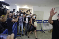 Aya Biran, center right, a paternal aunt of Eitan Biran, who survived a cable car crash in Italy that killed his immediate family, arrives to court in Tel Aviv on Thursday, Sept. 23, 2021 for a hearing in the alleged kidnapping of her nephew. The boy's parents and younger sibling were among 14 killed in May when a cable car slammed into a mountainside in northern Italy. He is now the focus of a custody battle between his maternal grandparents in Israel and his paternal relatives in Italy. (AP Photo/Sebastian Scheiner)