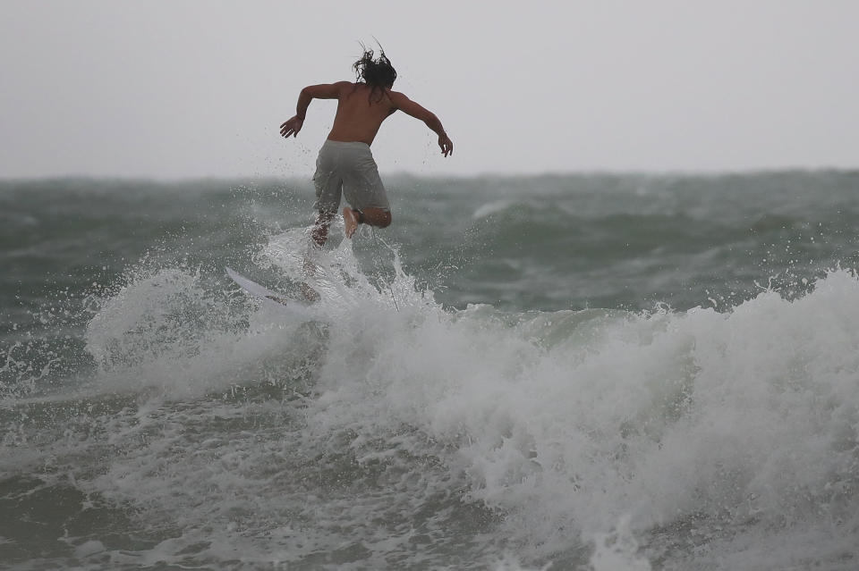 MIAMI BEACH, FL - SEPTEMBER 09:  A surfer enjoys the waves churned up buy the approaching Hurricane Irma on September 9, 2017 in Miami Beach, Florida. Florida is in the path of the Hurricane which may come ashore at  category 4.  (Photo by Joe Raedle/Getty Images)