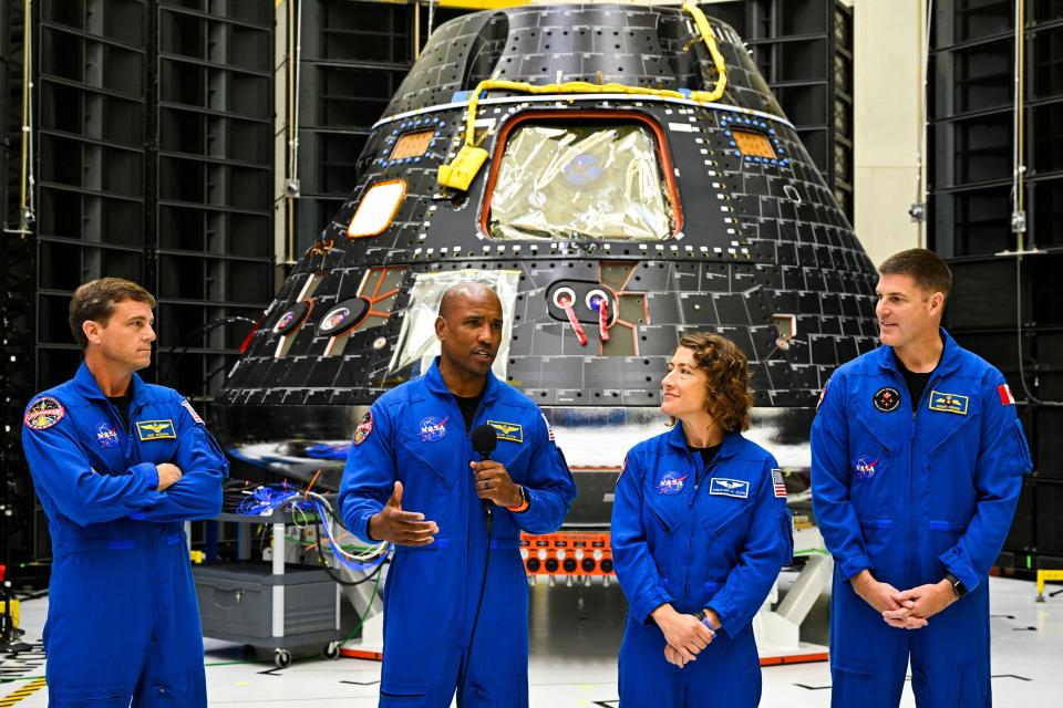 From left to right, U.S. astronauts Victor Glover, pilot; Reid Wiseman, commander; and mission specialists Christina Hammock Koch and Canadian astronaut Jeremy Hansen stand in front of the Artemis II crew module on Tuesday.