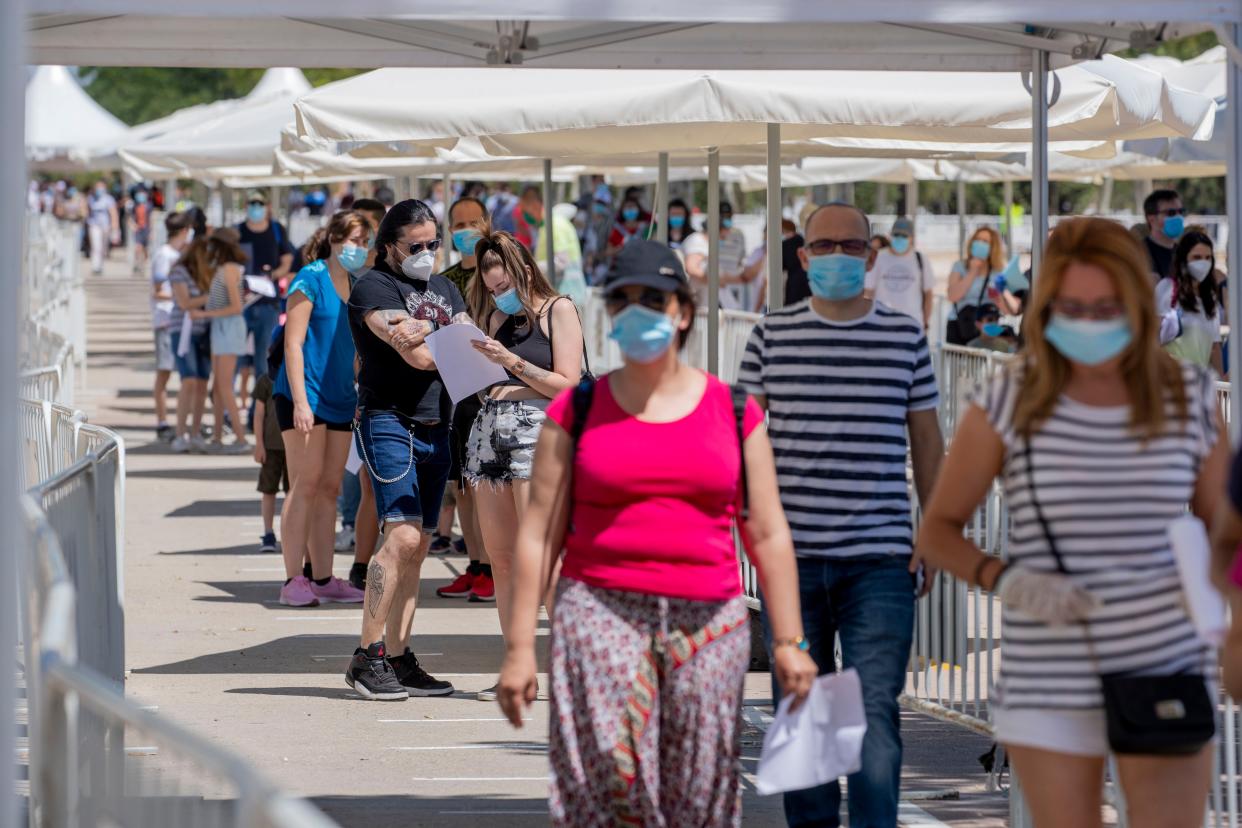 People queue in a temporary testing point where the city council has started to test for COVID-19 in Torrejon de Ardoz, Spain, on Friday, May 29, 2020. Spanish authorities are reporting no setbacks in their gradual easing of restrictions on movement over this past month, as some regions prepare to further loosen limits from June 1.