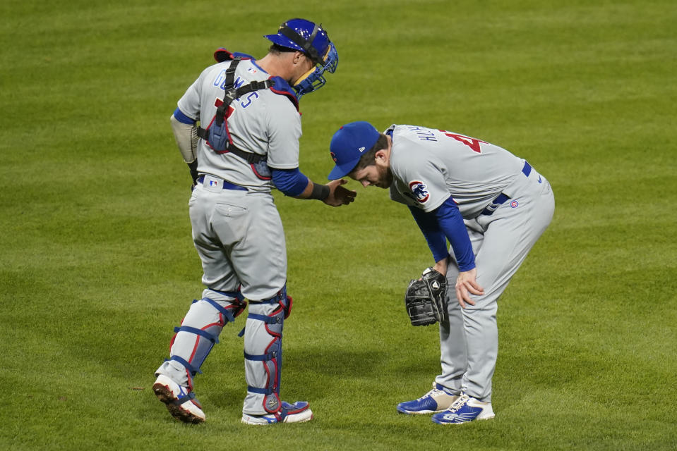 Chicago Cubs catcher Yan Gomes, left, checks on relief pitcher Brandon Hughes after a pitch, during the seventh inning of the team's baseball game against the Pittsburgh Pirates, Thursday, Sept. 22, 2022, in Pittsburgh. Hughes stayed in the game. (AP Photo/Keith Srakocic)