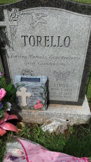 A deli bag of feces is left next to Linda Torello's grave.
