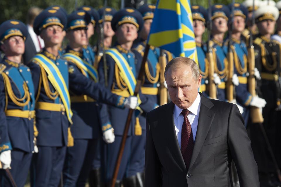 Russian President Vladimir Putin, foreground right, arrives to attend a laying ceremony in Kursk, 426 kilometers (266 miles) south of Moscow, Russia, Thursday, Aug. 23, 2018. Putin attends a ceremony marking the 75th anniversary of the battle of Kursk in which the Soviet army routed Nazi troops. It is described by historians as the largest tank battle in history involving thousands of tanks. (AP Photo/Alexander Zemlianichenko, Pool)