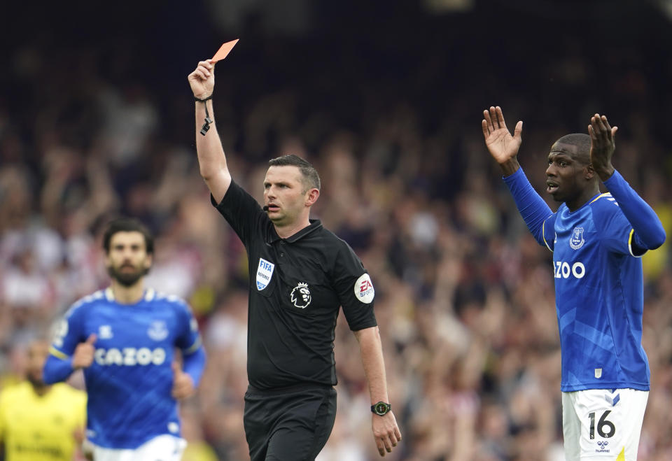 Referee Michael Oliver, centre, during the Premier League soccer match between Everton and Brentford at Goodison Park in Liverpool, England, Sunday, May 15, 2022. (AP Photo/Jon Super)