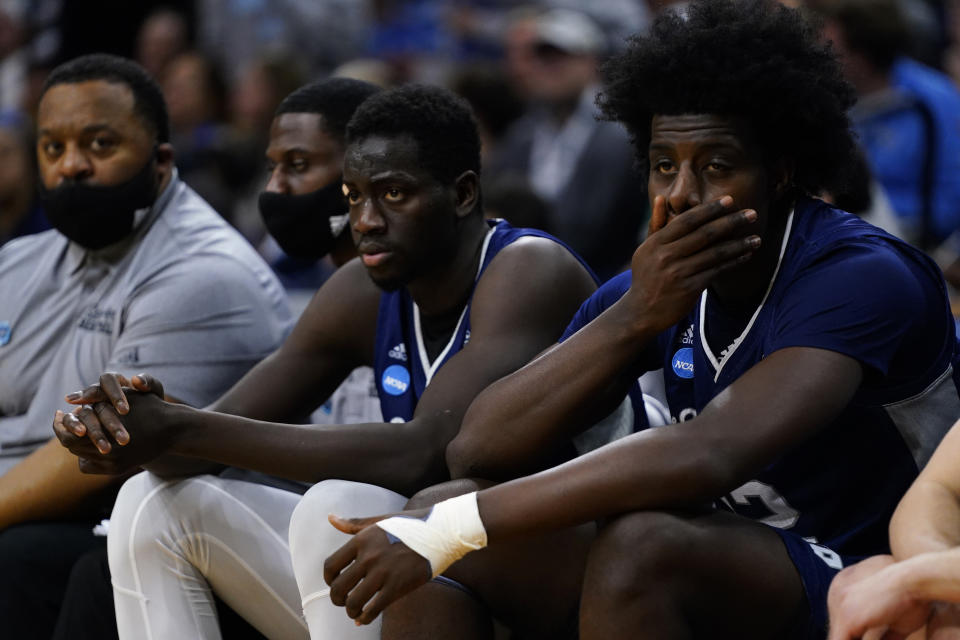 St. Peter's Clarence Rupert, right, and Fousseyni Drame watch from the bench during the second half of a college basketball game against North Carolina in the Elite 8 round of the NCAA tournament, Sunday, March 27, 2022, in Philadelphia. (AP Photo/Chris Szagola)