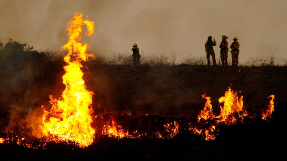 Fire crews light a controlled burn in an attempt to counteract the Cedar Fire on October 27, 2003, near Lakeside in San Diego, California. - Donald Miralle/Getty Images