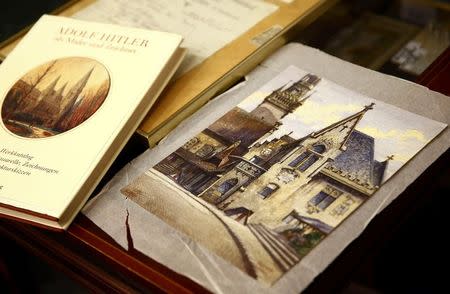 A watercolour of the old registry office in Munich by former German dictator Adolf Hitler lies next to a catalog of his paintings and drawings at Weidler auction house in Nuremberg November 18, 2014. REUTERS/Kai Pfaffenbach