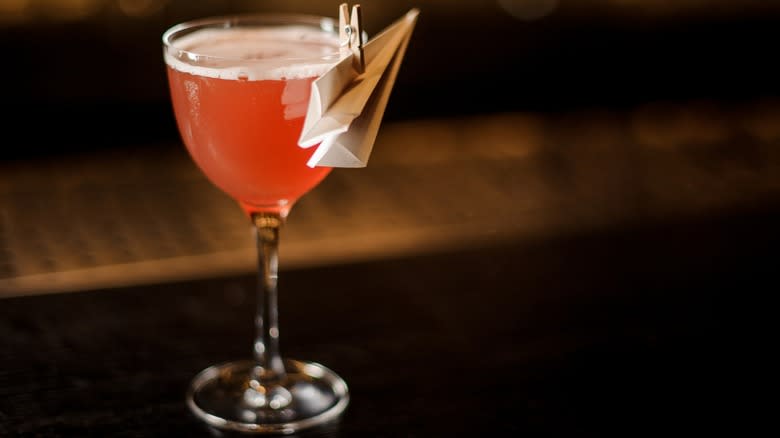 A Paper Plane cocktail with a black background