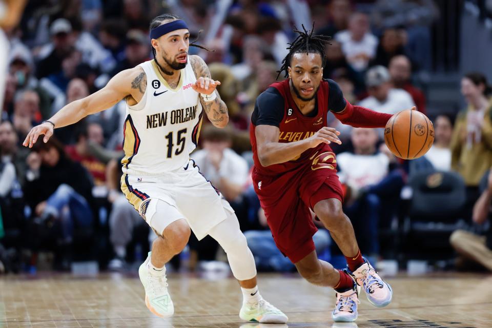 Cleveland Cavaliers guard Darius Garland, right, drives against New Orleans Pelicans guard Jose Alvarado (15) during the second half of an NBA basketball game, Monday, Jan. 16, 2023, in Cleveland. (AP Photo/Ron Schwane)