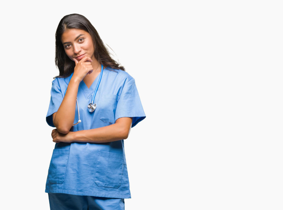 Female surgeon looking at camera with hand on chin