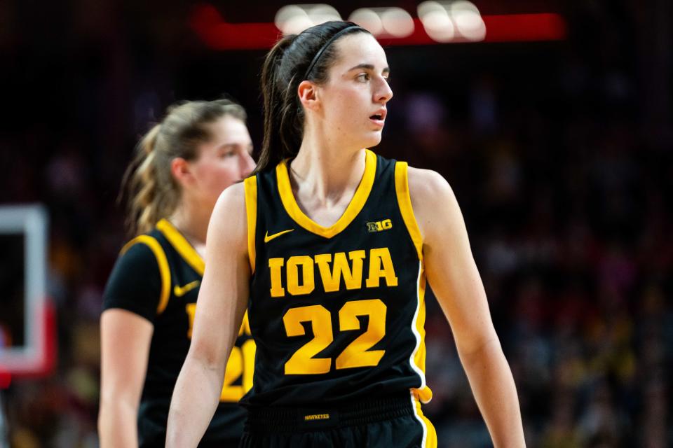 Iowa's Caitlin Clark looks to Iowa head coach Lisa Bluder as they await the inbounds pass to resume play Sunday, Feb. 11, 2024, at Pinnacle Bank Arena.