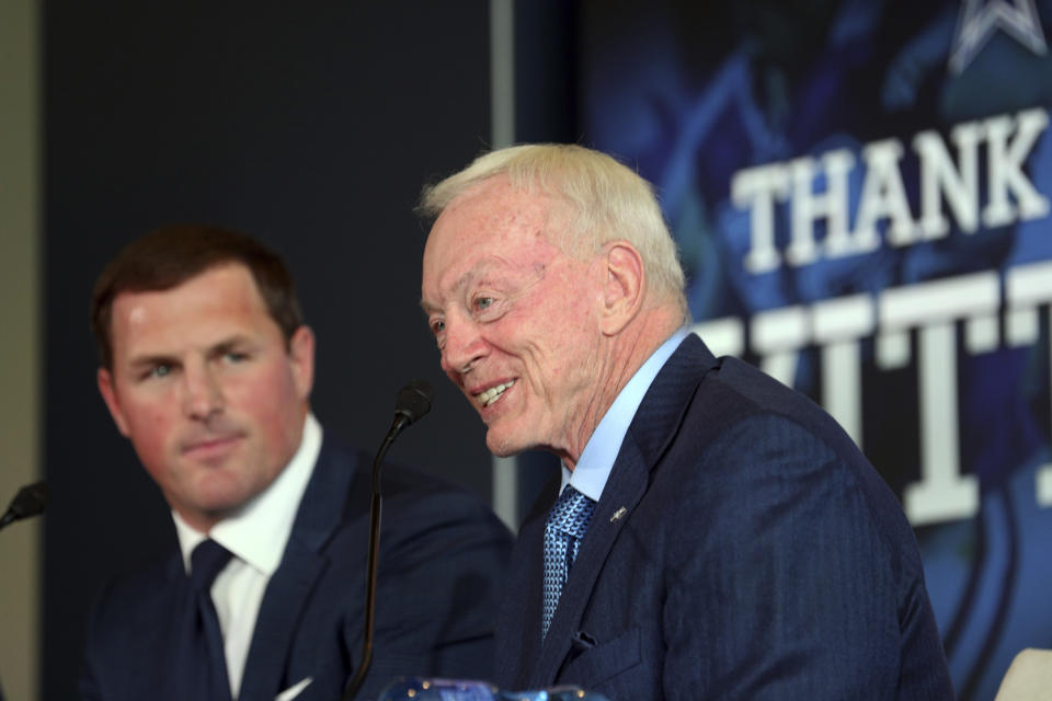 Jason Witten, left, listens to comments by Jerry Jones at Witten's retirement press conference. (AP)