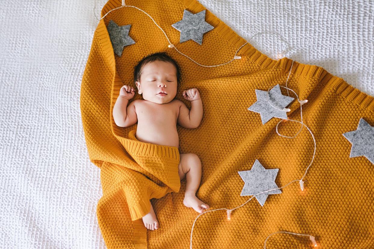 Cute newborn sleeping baby in yellow saffron color knitted blanket, real people, caucasian, 0-1 month