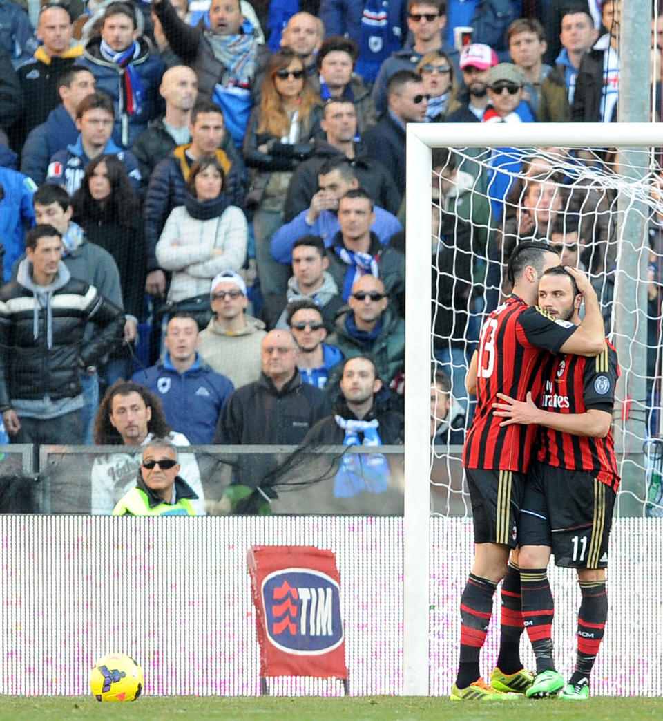 AC Milan's Adil Rami, left, hugs teammate Giampaolo Pazzini after scoring a goal during a Serie A soccer match between Sampdoria and AC Milan, at the Luigi Ferraris stadium in Genoa, Italy, Sunday, Feb. 23, 2014. (AP Photo / Carlo Baroncini)