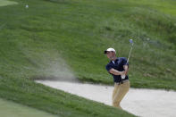 Rory McIlroy, of Northern Ireland, hits from a bunker toward the fourth hole during the second round of the Memorial golf tournament, Friday, July 17, 2020, in Dublin, Ohio. (AP Photo/Darron Cummings)