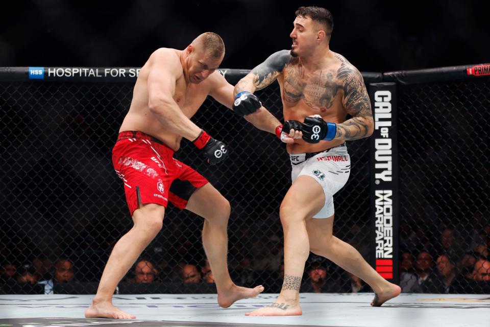 NEW YORK, NEW YORK – NOVEMBER 11: (RL) Tom Aspinall of England punches Sergei Pavlovich of Russia in the interim UFC heavyweight title fight during the UFC 295 event at Madison Square Garden on November 11 2023 in New York City.  (Photo by Sarah Stier/Getty Images)