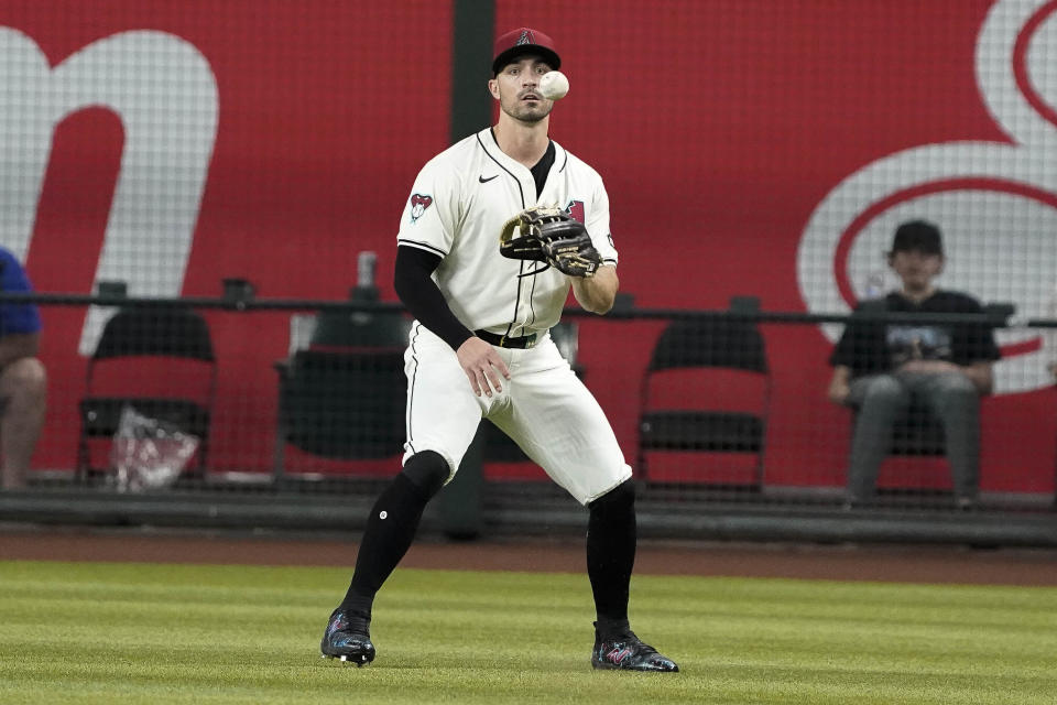 Arizona Diamondbacks outfielder Randal Grichuk watches Chicago Cubs' Dansby Swanson single drop in front of him during the first inning of a baseball game Wednesday, April 17, 2024, in Phoenix. (AP Photo/Darryl Webb)