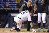 Miami Marlins' Jon Berti (5) has ice applied to his back after being hit by a pitch thrown by San Diego Padres reliever Austin Adams during the seventh inning of a baseball game, Thursday, July 22, 2021, in Miami. (AP Photo/Lynne Sladky)