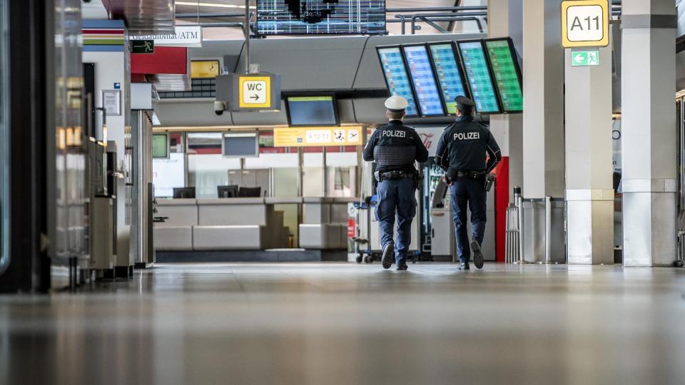 Polizisten patrouillieren am Flughafen Berlin-Tegel durch das Terminal.
