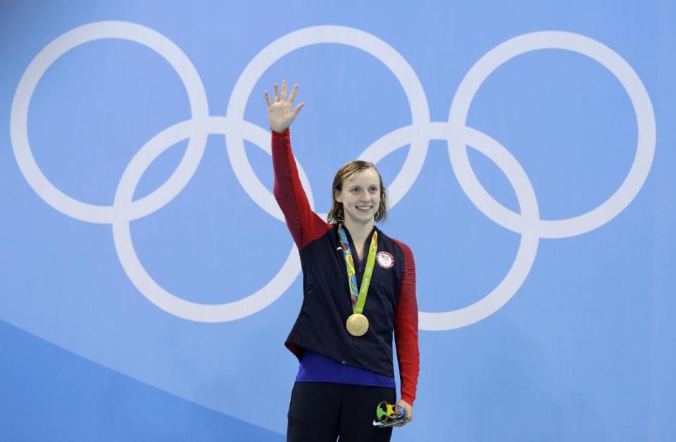 United States' gold medal winner Katie Ledecky celebrates during the medal ceremony after setting a new world record in the women's 400-meter freestyle final during the swimming competitions at the 2016 Summer Olympics, Monday, Aug. 8, 2016, in Rio de Janeiro, Brazil. (AP Photo/Michael Sohn)