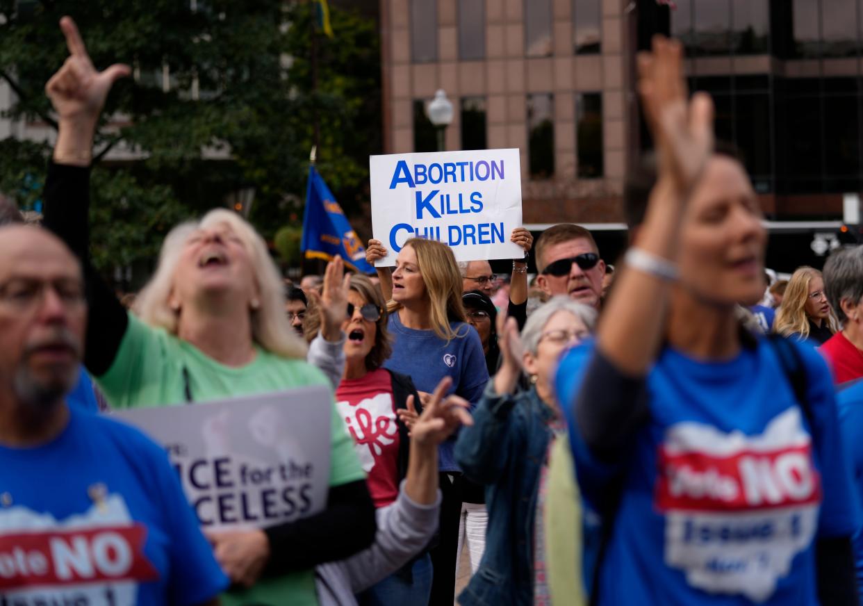 People gather and pray during the Ohio March for Life, at the Ohio State House in Columbus, Ohio, Friday, Oct. 6, 2023. As campaigning escalates in Ohio’s fall fight over abortion rights, a new line of attack from opponents suggests “partial-birth” abortions would be revived if a proposed constitutional amendment passes.