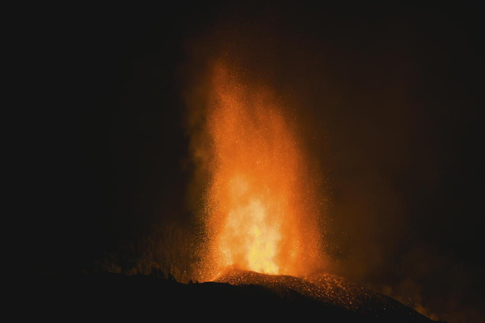 Lava flows from an eruption of a volcano near El Paso on the island of La Palma in the Canaries, Spain, in the early hours of Monday, Sept. 20, 2021. Lava continues to flow slowly from a volcano that erupted in Spain’s Canary Islands off northwest Africa. The head of the islands' regional government says Monday he expects no injuries to people in the area after some 5,000 were evacuated.(AP Photo/Jonathan Rodriguez)