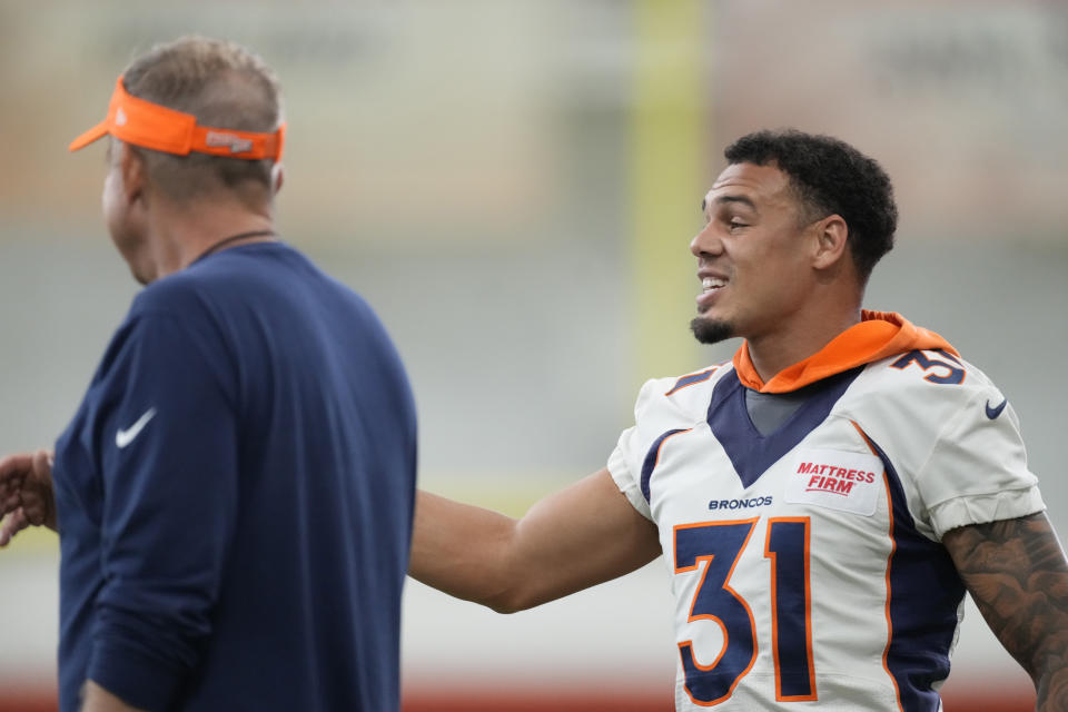 Denver Broncos safety Justin Simmons, right, chats with head coach Sean Payton during a mandatory NFL football minicamp at the Broncos' headquarters Tuesday, June 13, 2023, in Centennial, Colo. (AP Photo/David Zalubowski)