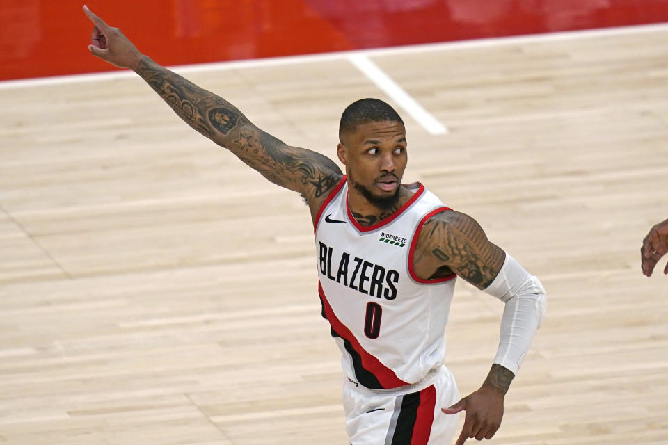 Portland Trail Blazers guard Damian Lillard runs upcourt after scoring against the Utah Jazz during the second half of an NBA basketball game Wednesday, May 12, 2021, in Salt Lake City. (AP Photo/Rick Bowmer)