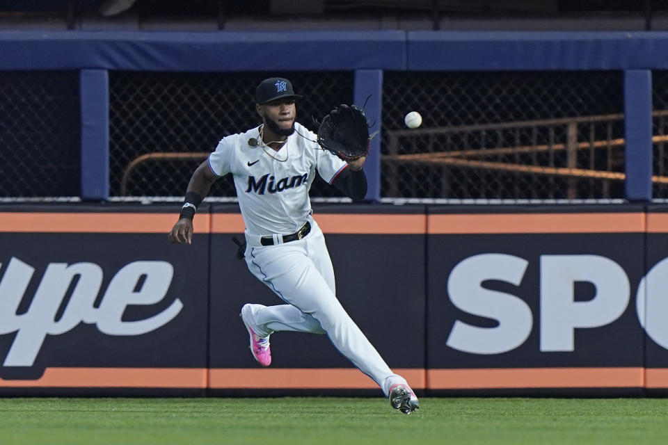 Miami Marlins right fielder Bryan De La Cruz fields a ball hit by New York Mets' Daniel Vogelbach for a base hit, during the first inning of a baseball game, Sunday, July 31, 2022, in Miami. (AP Photo/Wilfredo Lee)
