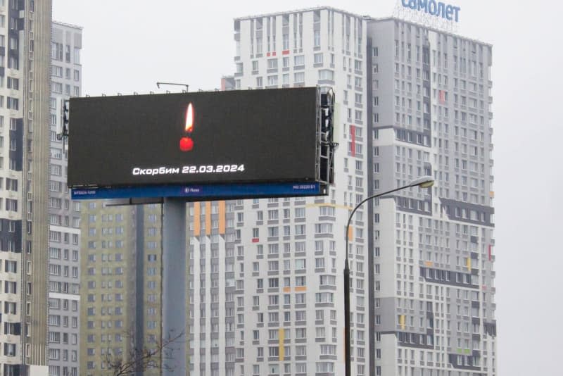 A billboard displaying a burning candle following an attack at a popular concert hall complex on Friday where assailants stormed the venue with guns and incendiary devices, killing at least 100 people and injuring hundreds. Vlad Karkov/SOPA Images via ZUMA Press Wire/dpa