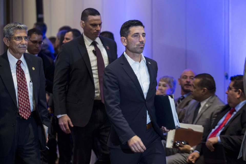 Acting Secretary of Homeland Security Chad F. Wolf, center, walks after a conference with interior ministers of El Salvador, Honduras and Guatemala in Guatemala City, Thursday, Dec. 12, 2019. (AP Photo/ Oliver de Ros)