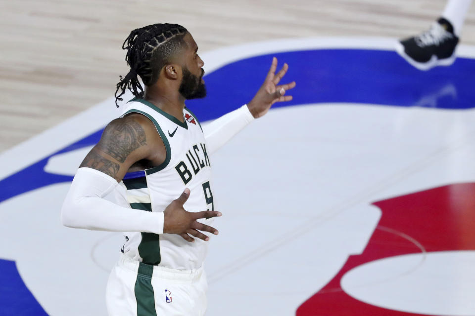 Milwaukee Bucks guard Wesley Matthews (9) reacts after making a 3-point basket against the Orlando Magic during the first half of Game 1 of an NBA basketball first-round playoff series, Tuesday, Aug. 18, 2020, in Lake Buena Vista, Fla. (Kim Klement/Pool Photo via AP)