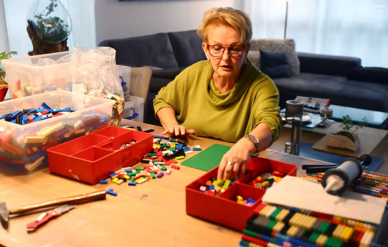 Rita Ebel, nicknamed "Lego grandma", builds a wheelchair ramp from donated Lego bricks in the living room of her flat in Hanau